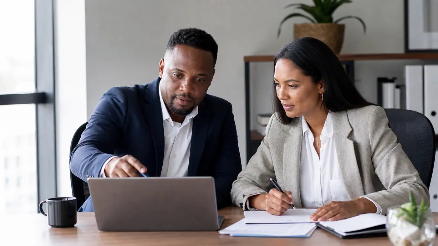South African sales manager and finance colleague reviewing a commission calculation together